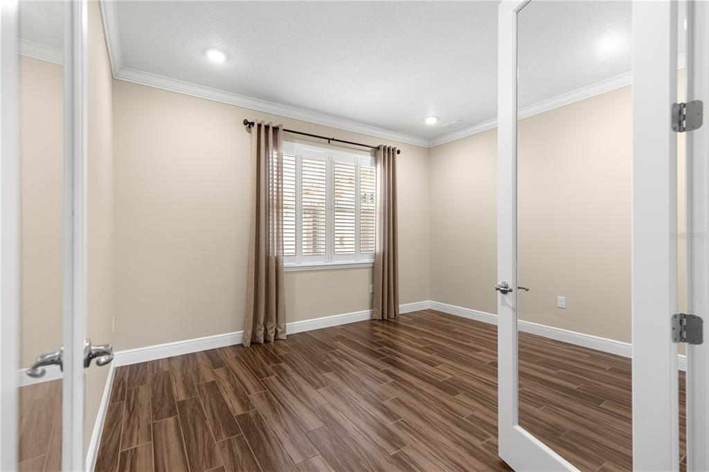 9460 Southwest 86th Place Ocala, FL 34481 - Photo 9 of 86 an empty room with wooden floor and a window
