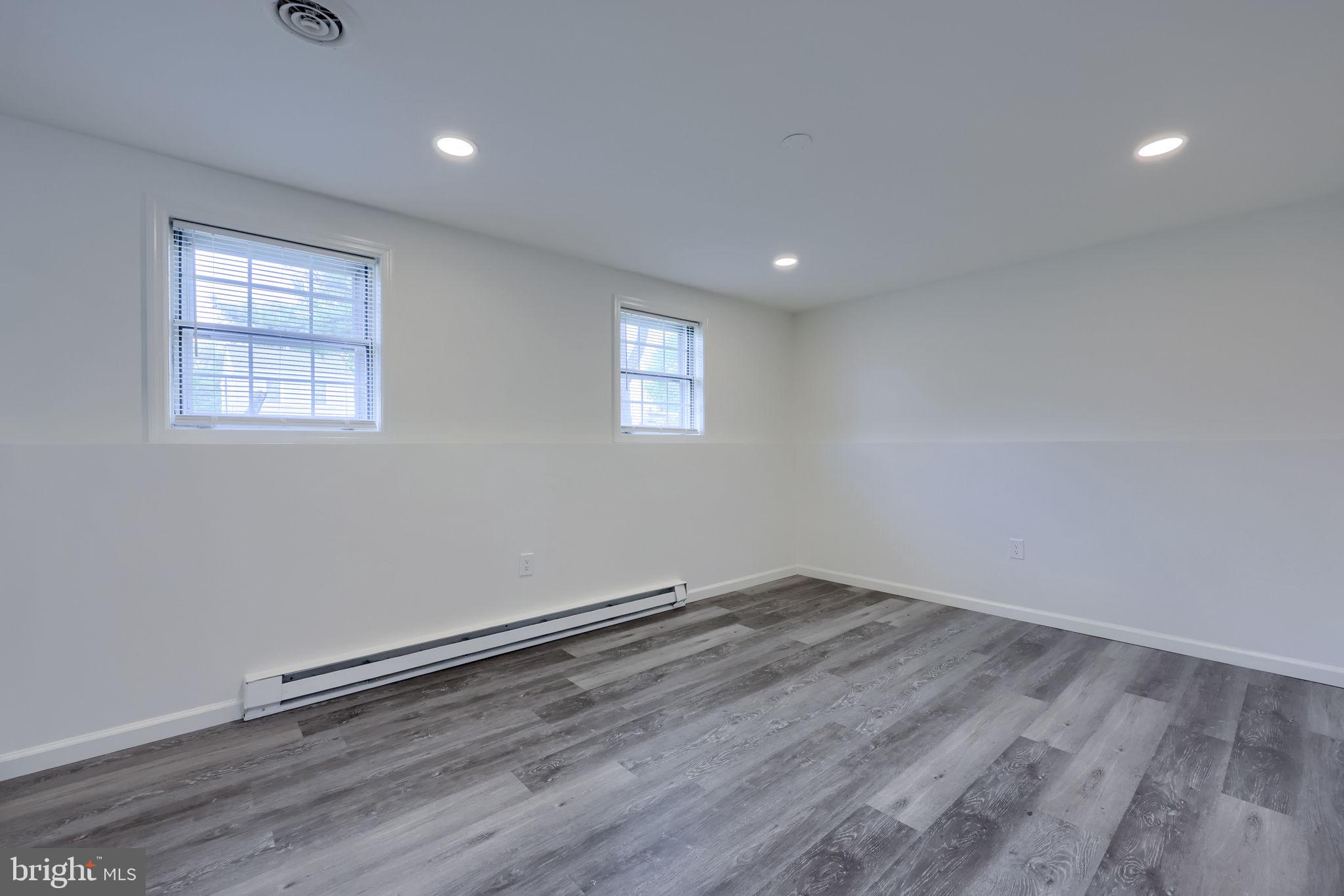 106 Warren Way Lancaster, PA 17601 - Photo 16 of 32 an empty room with wooden floor and windows