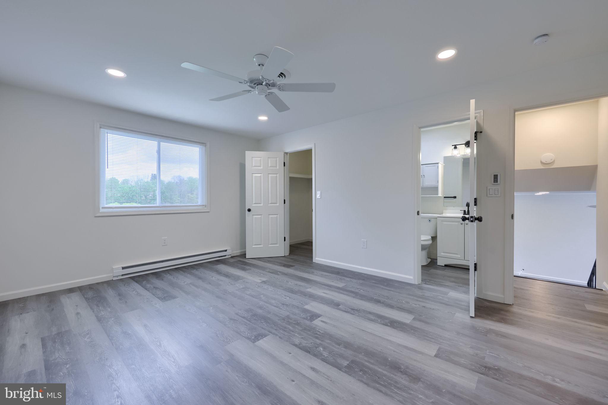 106 Warren Way Lancaster, PA 17601 - Photo 22 of 32 a view of an empty room with wooden floor and a window