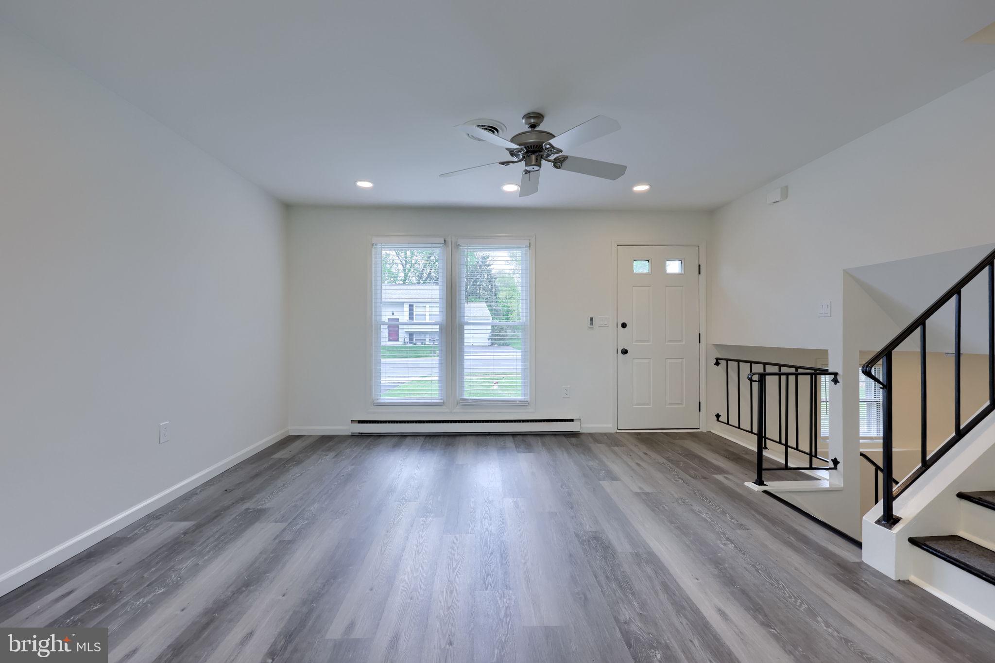 106 Warren Way Lancaster, PA 17601 - Photo 10 of 32 a view of an empty room with wooden floor and a window