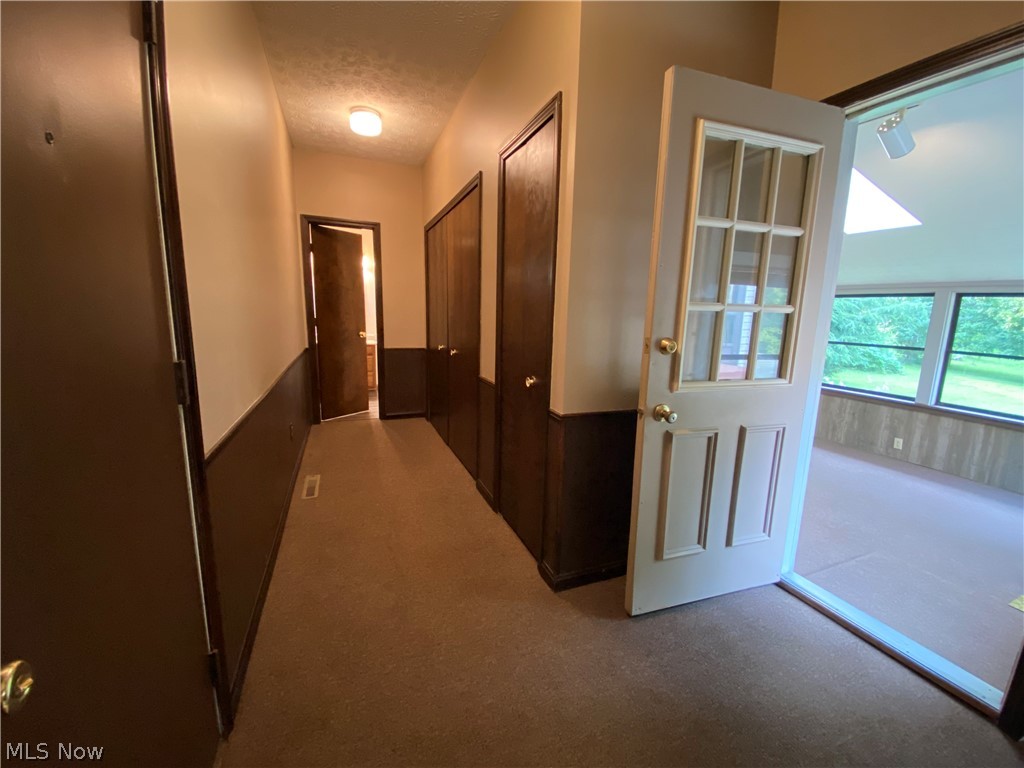 1825 Lynn Road Kent, OH 44240 - Photo 13 of 30 Hallway to the lower level bathroom and 4-season room