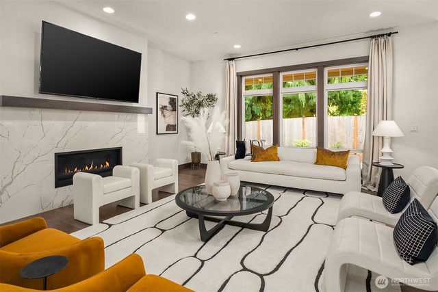 a living room with fireplace furniture and a flat screen tv