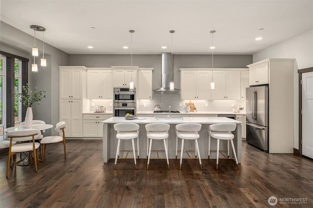 a large kitchen with a table and chairs