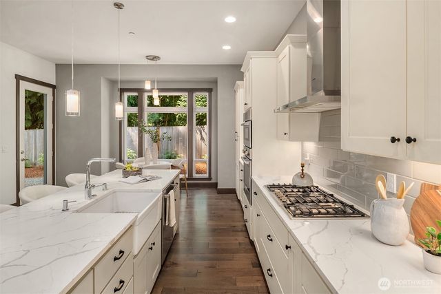 a kitchen with kitchen island a sink stove and cabinets