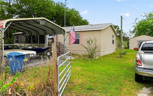 a view of house with backyard and sitting area