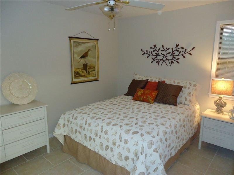 3799 East County Highway 30A, Unit C1 Santa Rosa Beach, FL 32459 - Photo 6 of 8 a bedroom with a bed and a chandelier