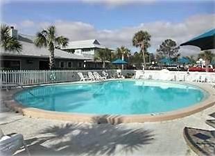 3799 East County Highway 30A, Unit C1 Santa Rosa Beach, FL 32459 - Photo 7 of 8 a view of a house with a swimming pool and a yard