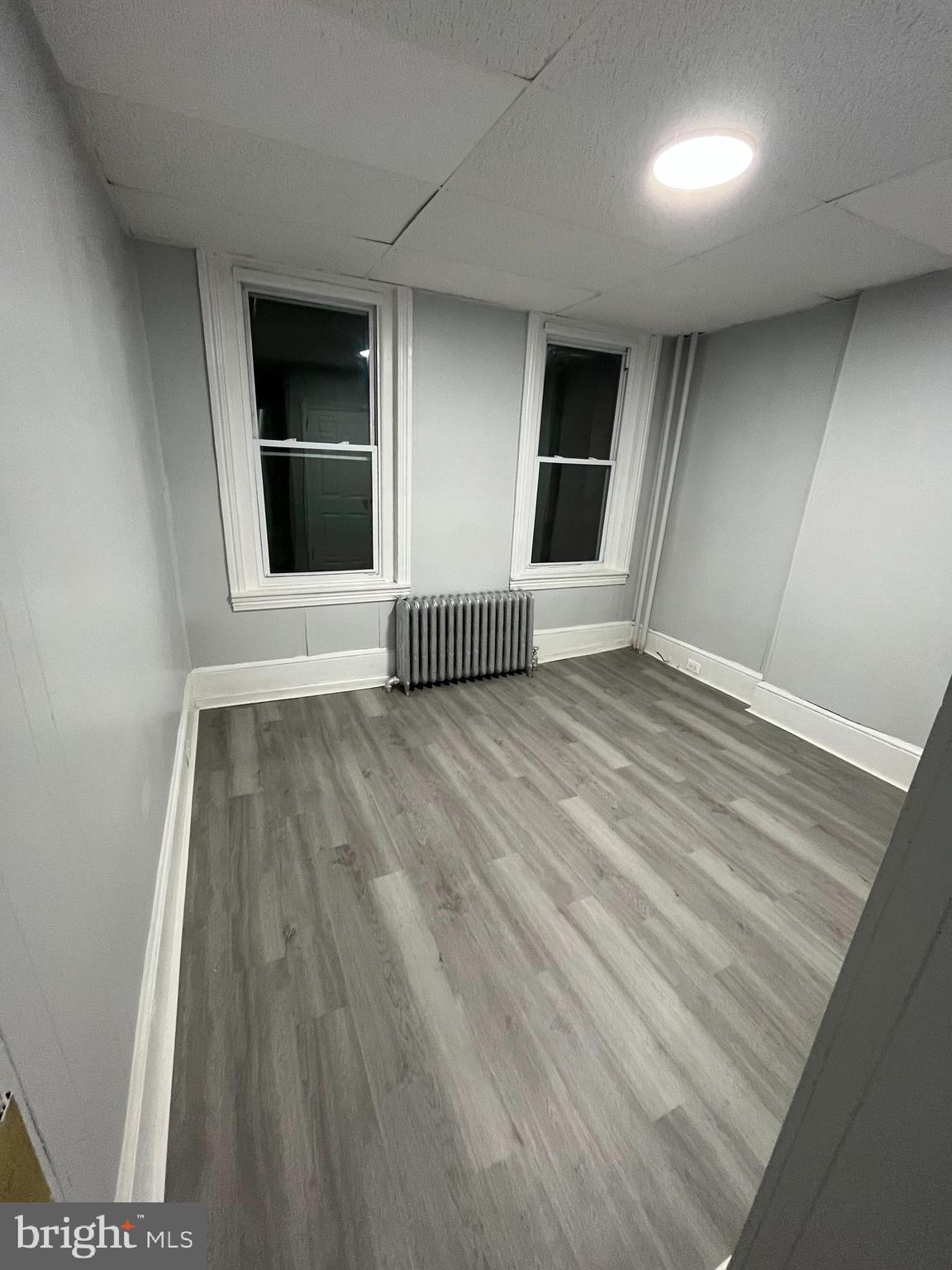 1115 Potter Street, Unit 2 Chester, PA 19013 - Photo 12 of 12 an empty room with wooden floor and windows