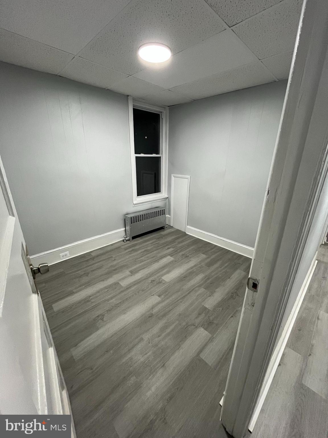 1115 Potter Street, Unit 2 Chester, PA 19013 - Photo 10 of 12 an empty room with windows