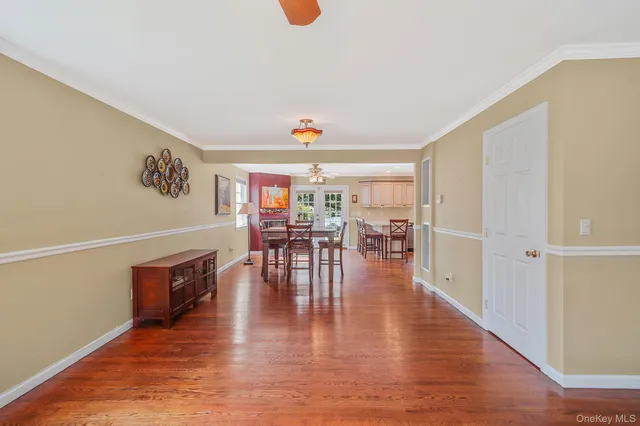 a view of entryway and dining room with wooden floor
