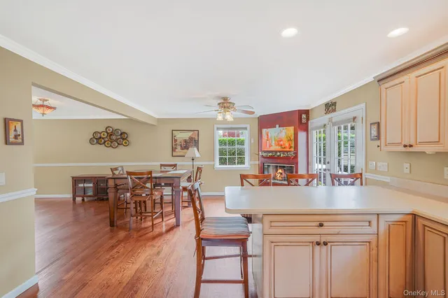 a view of a livingroom with wooden floor and a refrigerator
