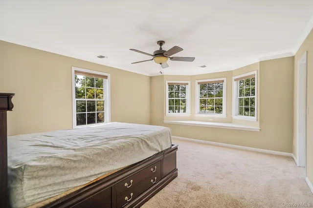 a room with a bed and a ceiling fan in it