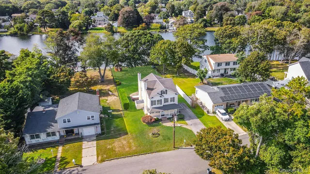 an aerial view of a house with a swimming pool and outdoor seating