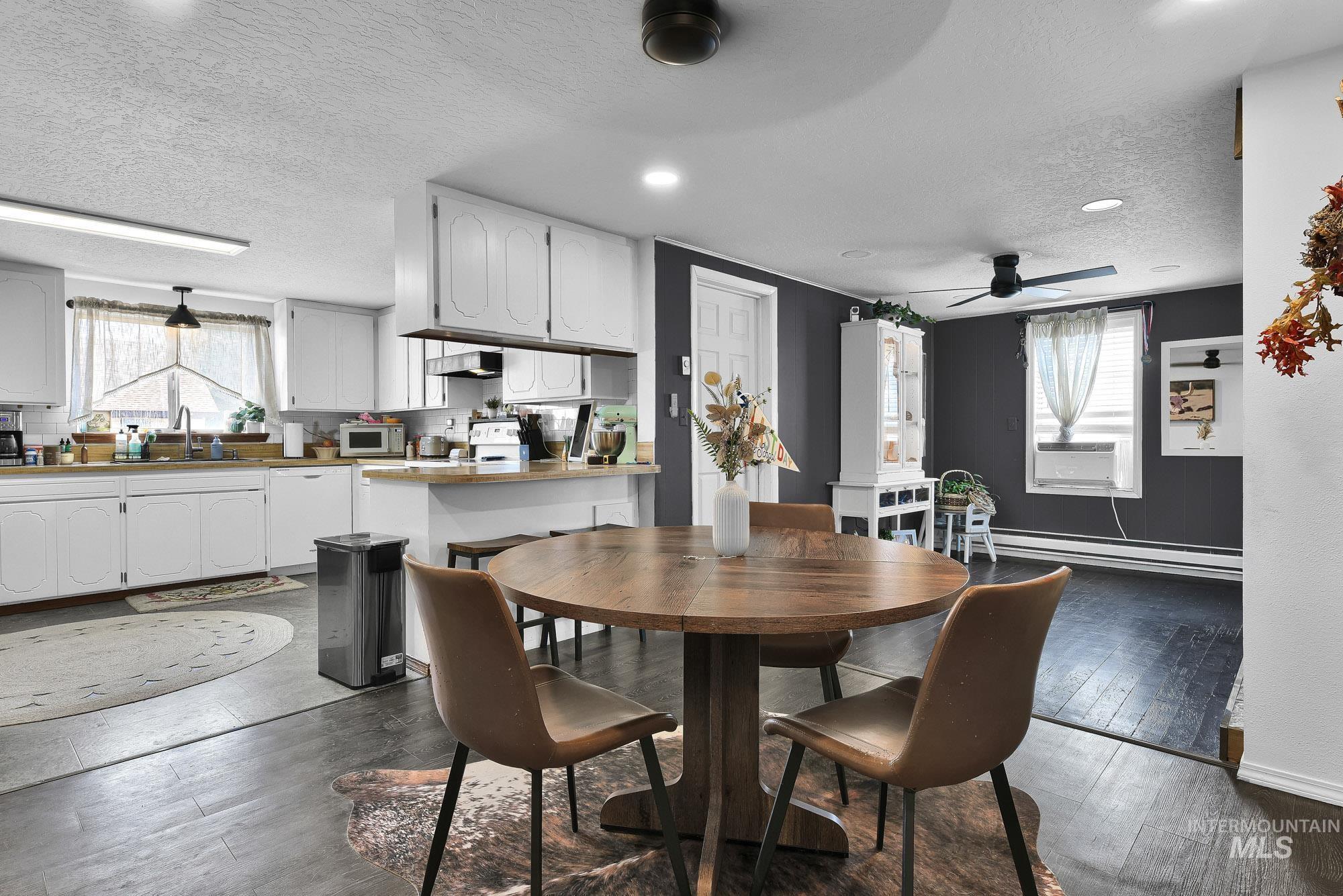 24900 Market Road Parma, ID 83660 - Photo 37 of 50 Open-concept dining area featuring wood-finish flooring, a contemporary ceiling fan, and recessed lighting