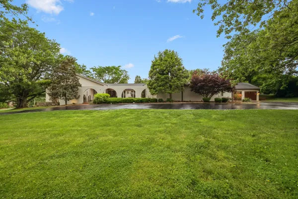 a view of house with garden space and trees