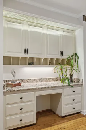 a kitchen with stainless steel appliances granite countertop a stove top oven a sink dishwasher and a refrigerator with wooden floor