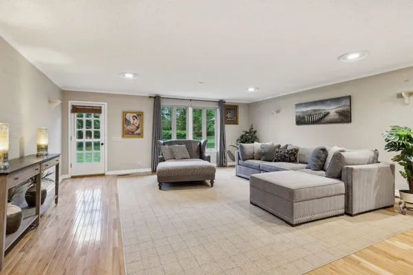 a view of a balcony with wooden floor and outdoor seating