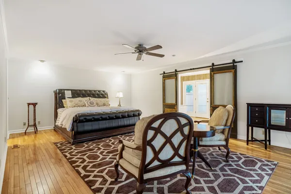 a view of empty room with wooden floor and window