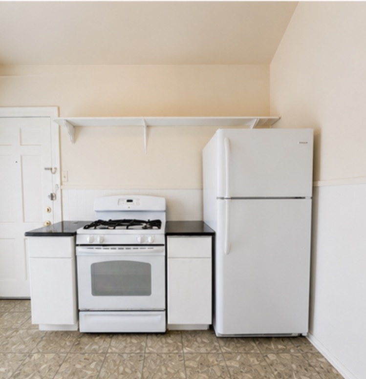 2509 Enfield Road, Unit A Austin, TX 78703 - Photo 5 of 6 Functional kitchen with essential appliances provides a convenient culinary space.
