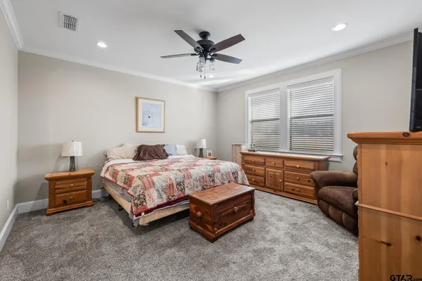 a bedroom with a bed window and a couch