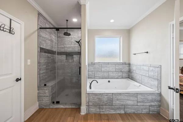a bathroom with a bathtub and a shower