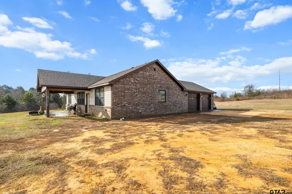 a view of a house with a yard and garage