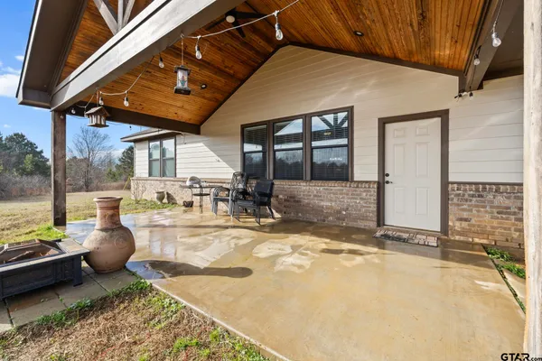 a view of a backyard with seating space