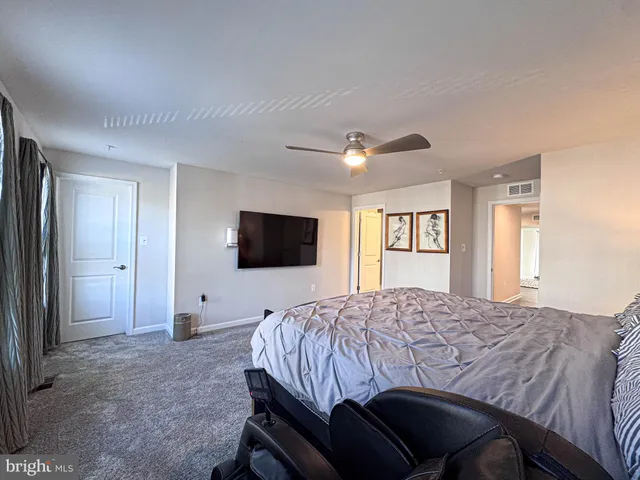 a bedroom with a bed and a television