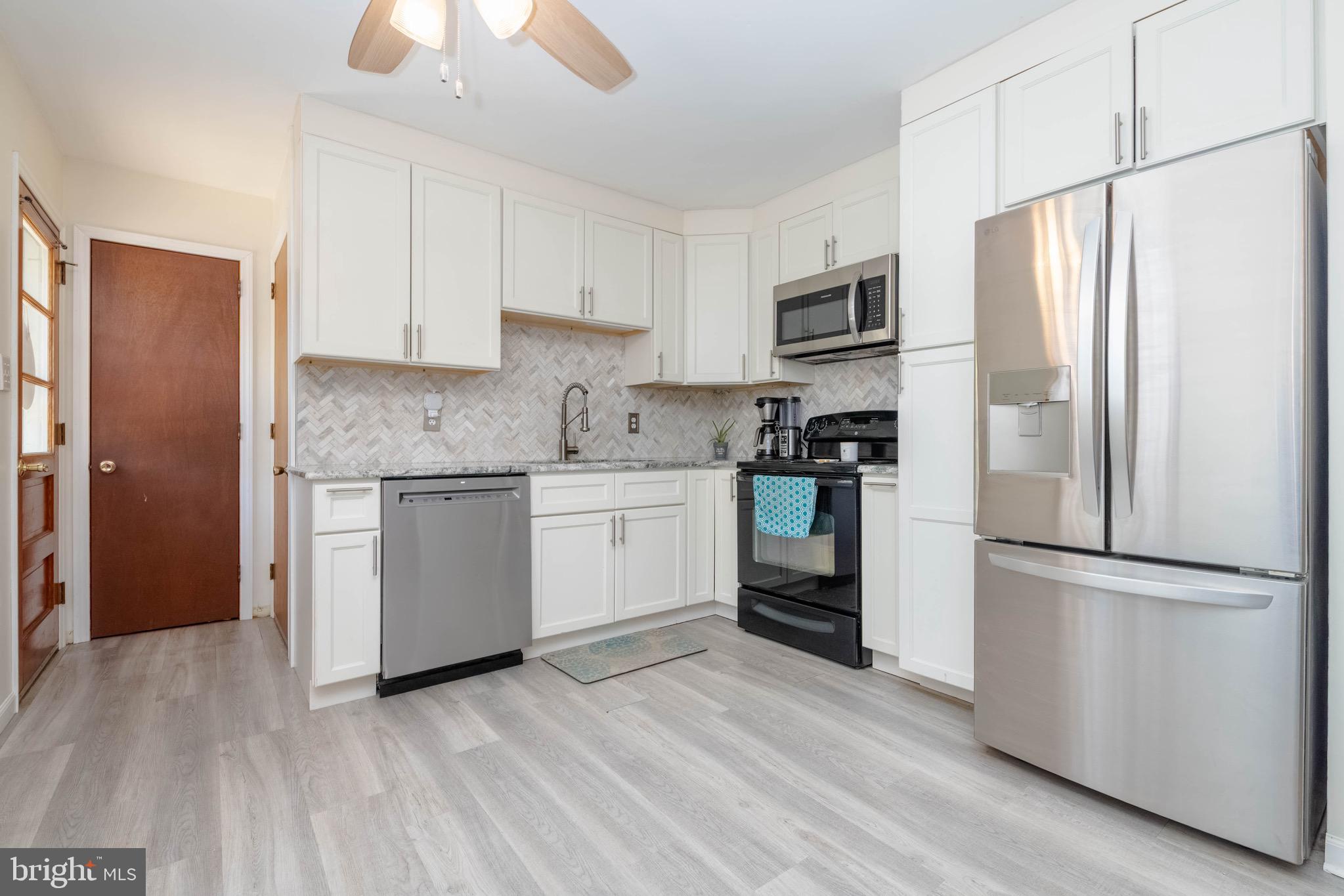4007 Lee Road Aberdeen, MD 21001 - Photo 21 of 57 a kitchen with stainless steel appliances a refrigerator sink and cabinets