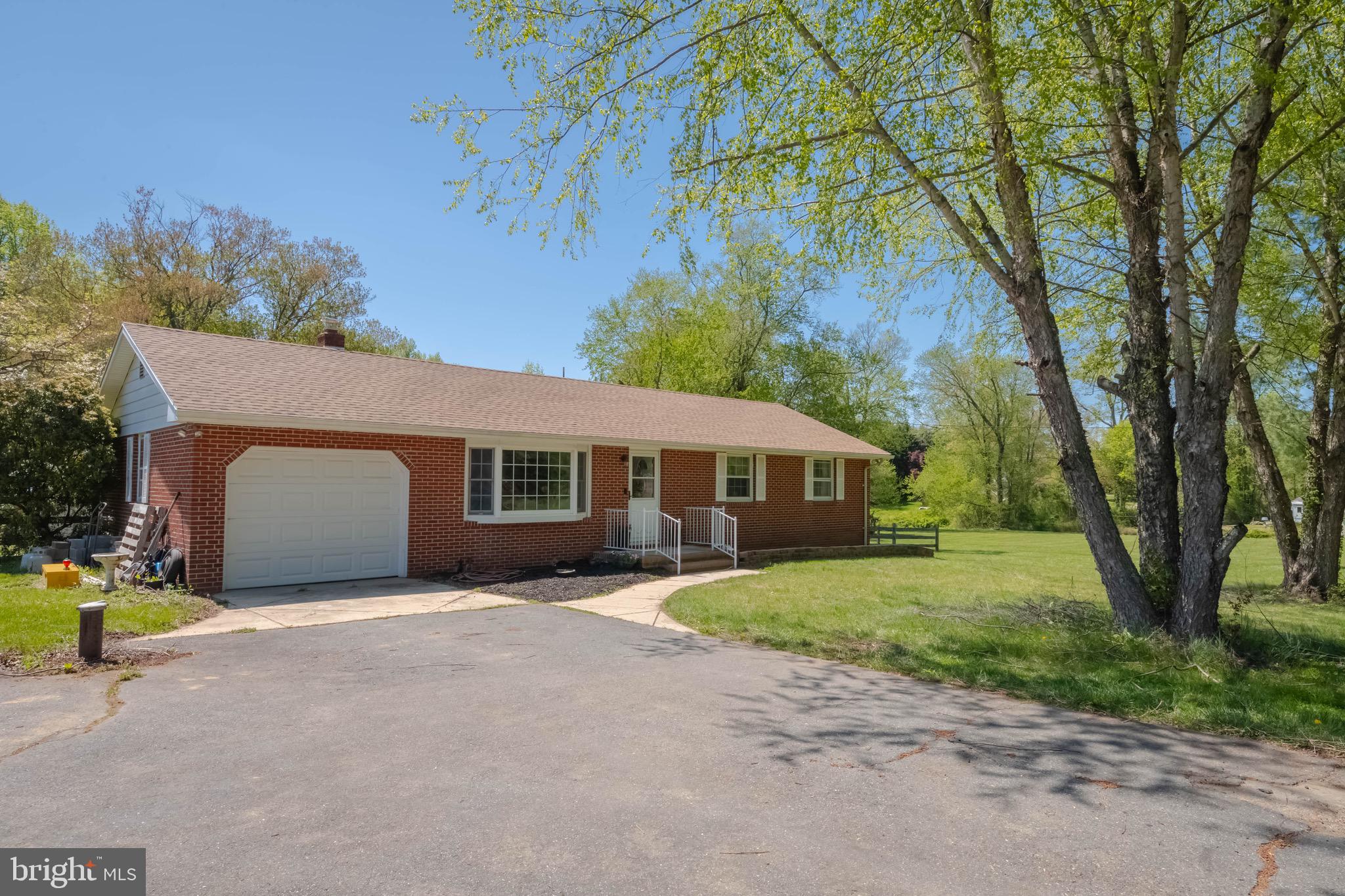 4007 Lee Road Aberdeen, MD 21001 - Photo 6 of 57 a front view of a house with a yard and garage