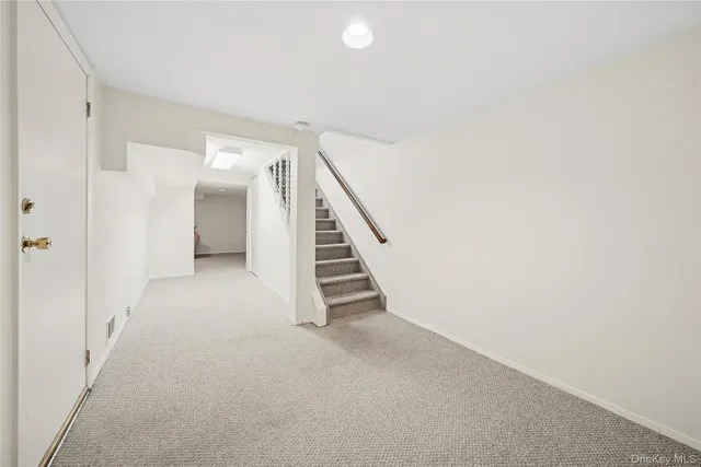 a view of an empty room with stairs
