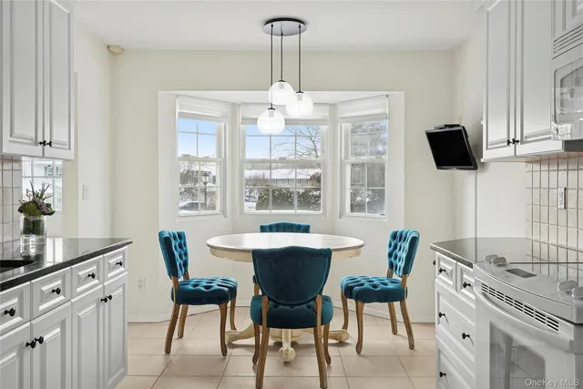 a dining room with furniture and window