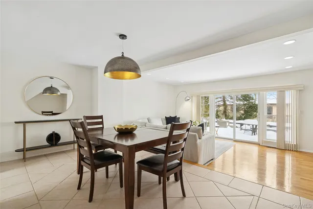 a dining room with furniture and a large window