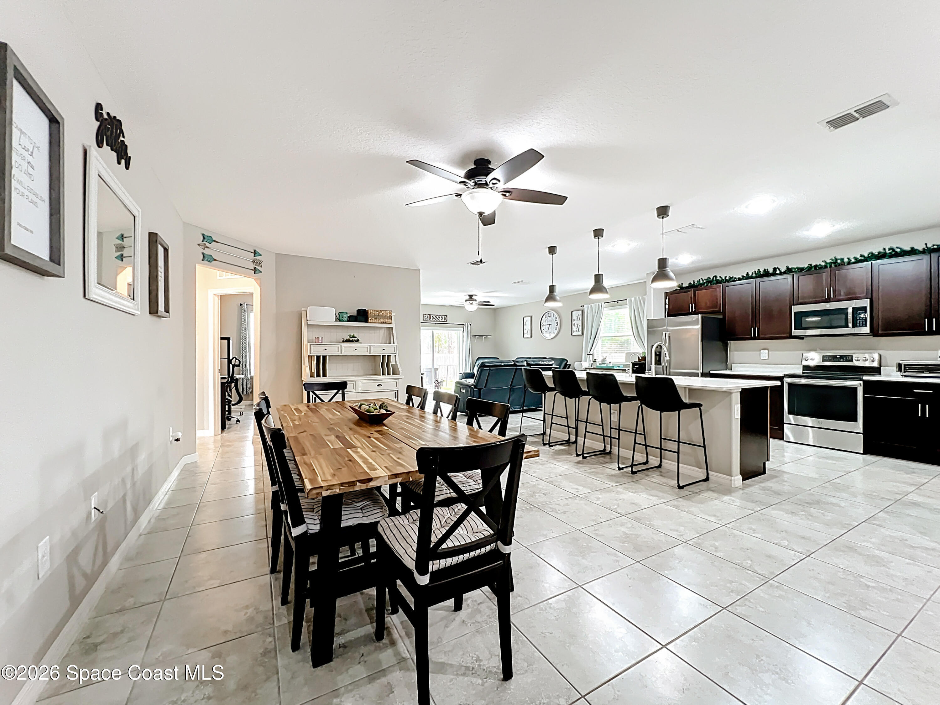 415 Scodella Street Southwest Palm Bay, FL 32908 - Photo 12 of 54 a view of a dining room kitchen and dining room