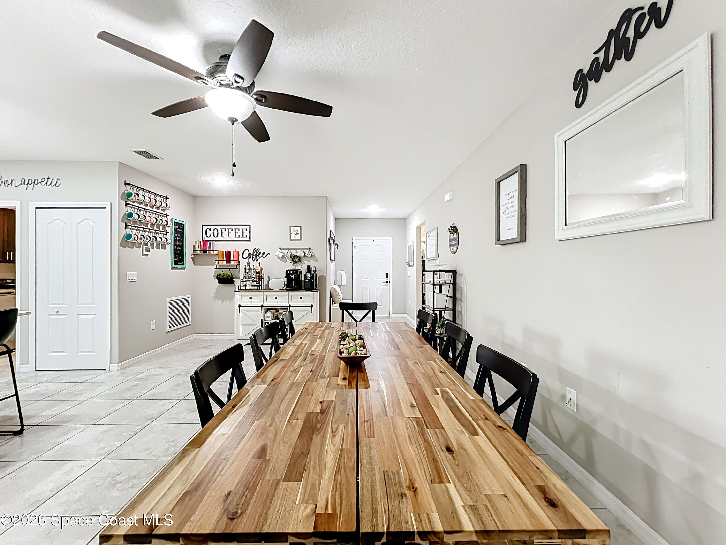 415 Scodella Street Southwest Palm Bay, FL 32908 - Photo 14 of 54 a view of a living room a dining room with wooden floor and furniture
