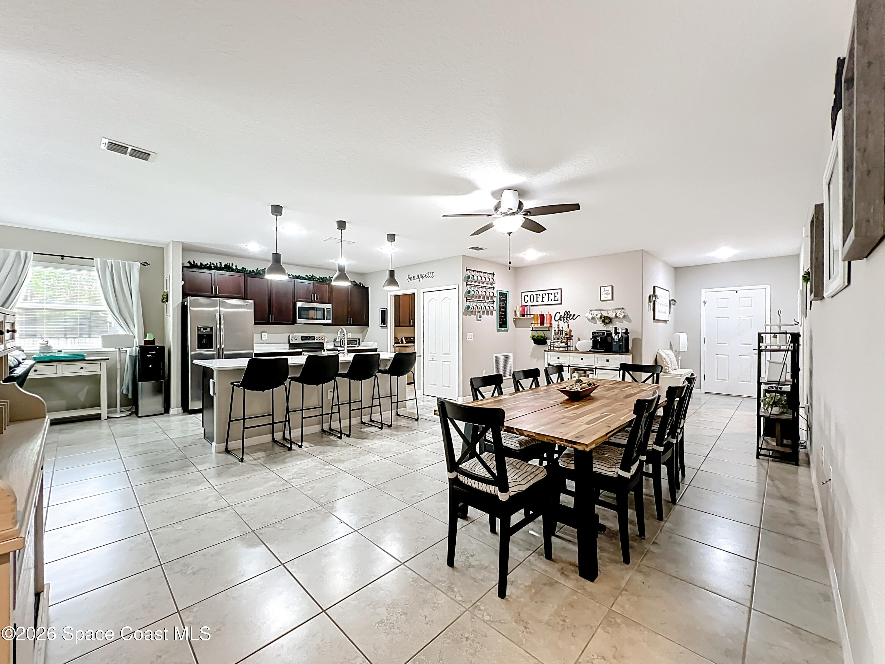 415 Scodella Street Southwest Palm Bay, FL 32908 - Photo 15 of 54 a view of a dining area with furniture
