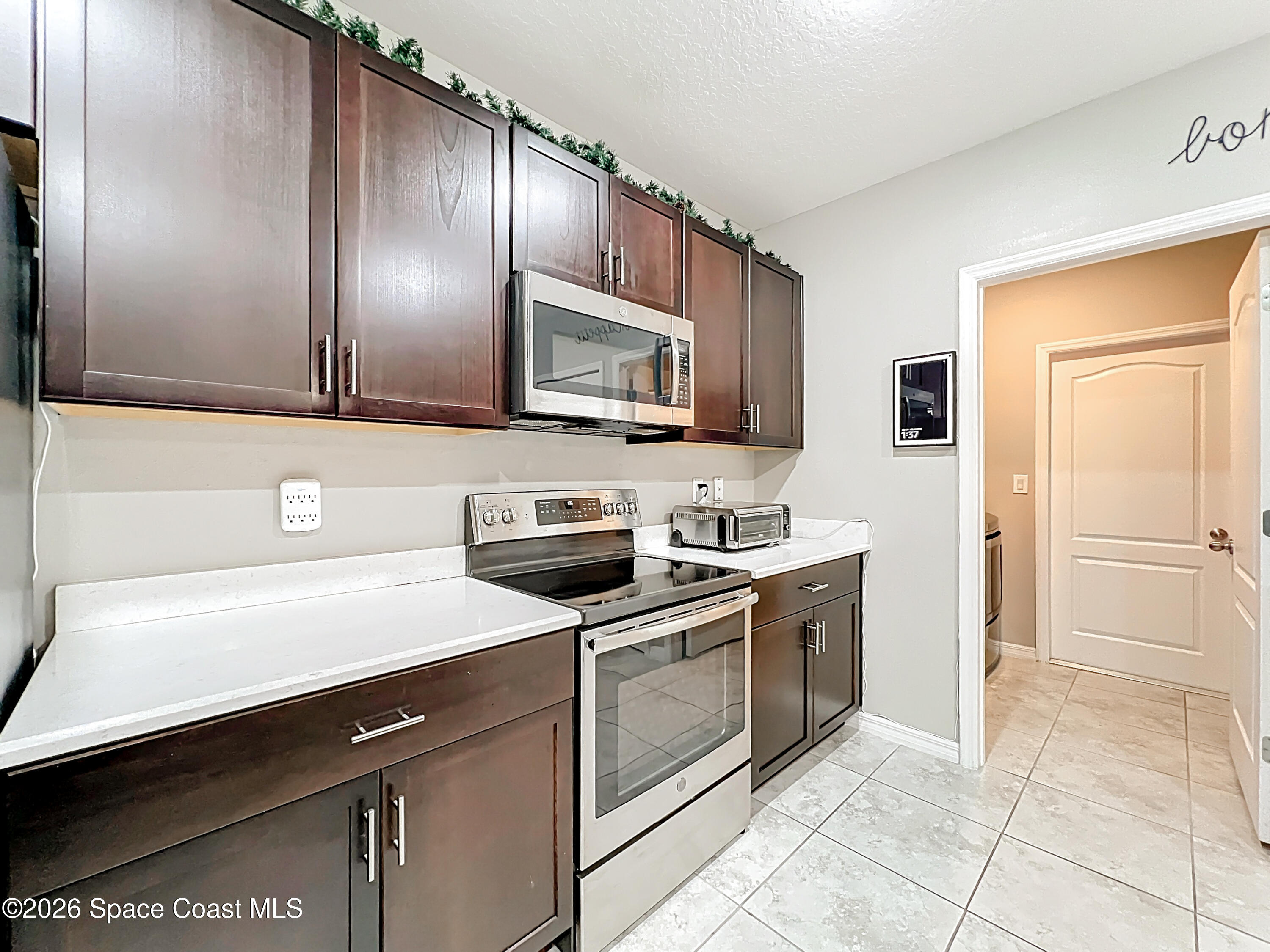 415 Scodella Street Southwest Palm Bay, FL 32908 - Photo 21 of 54 a kitchen with a sink cabinets and stainless steel appliances