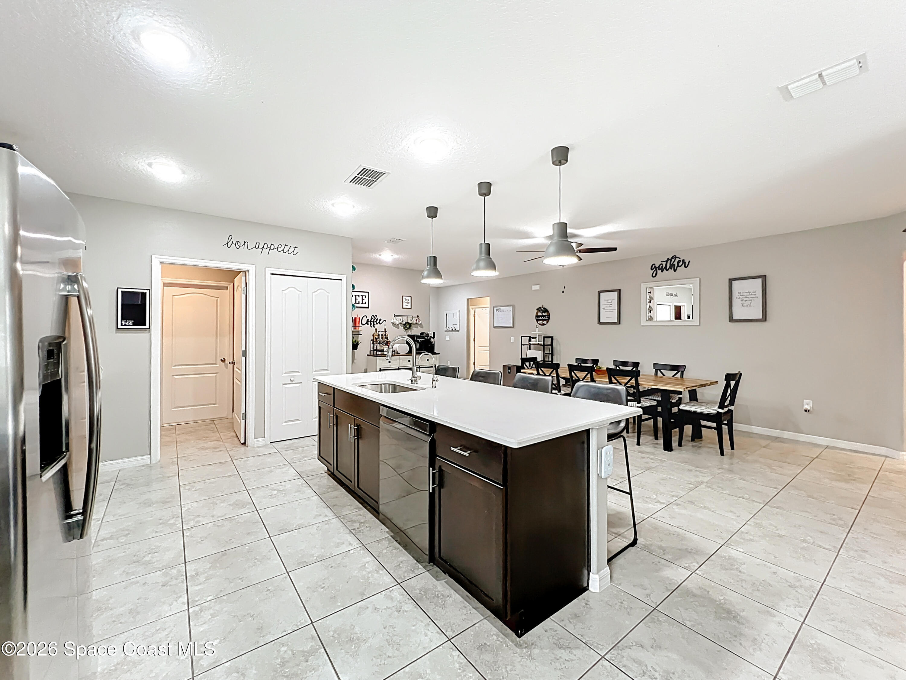 415 Scodella Street Southwest Palm Bay, FL 32908 - Photo 23 of 54 a kitchen with a sink and a refrigerator