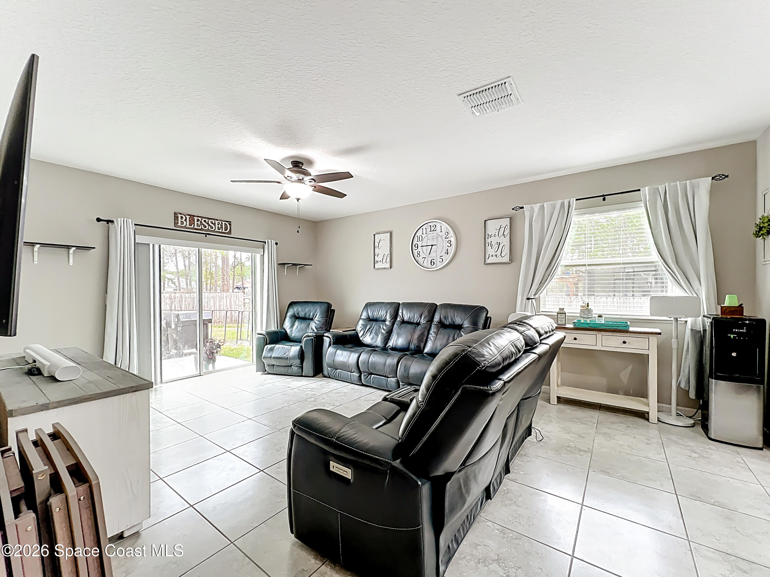 415 Scodella Street Southwest Palm Bay, FL 32908 - Photo 27 of 54 a living room with furniture and a window