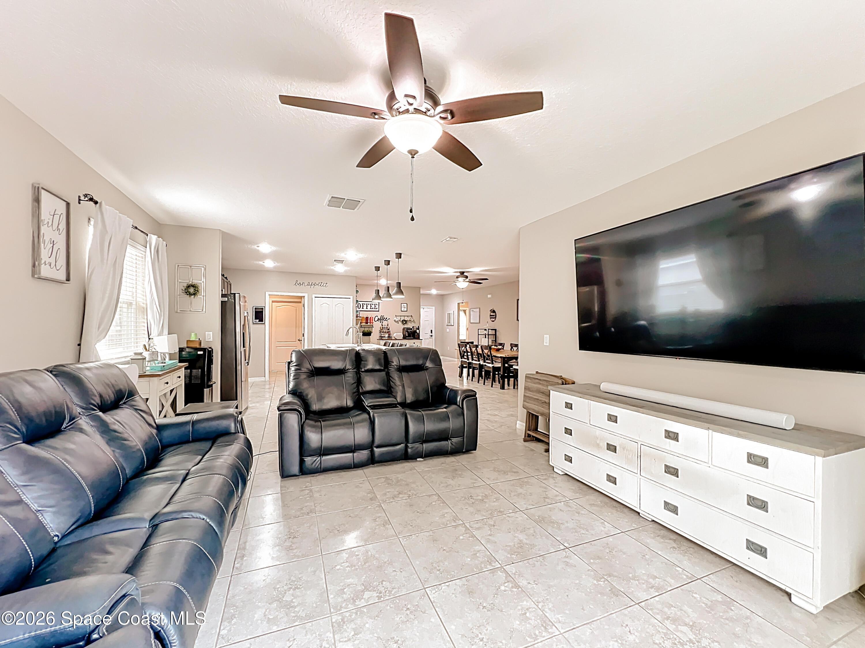 415 Scodella Street Southwest Palm Bay, FL 32908 - Photo 29 of 54 a living room with furniture and a flat screen tv