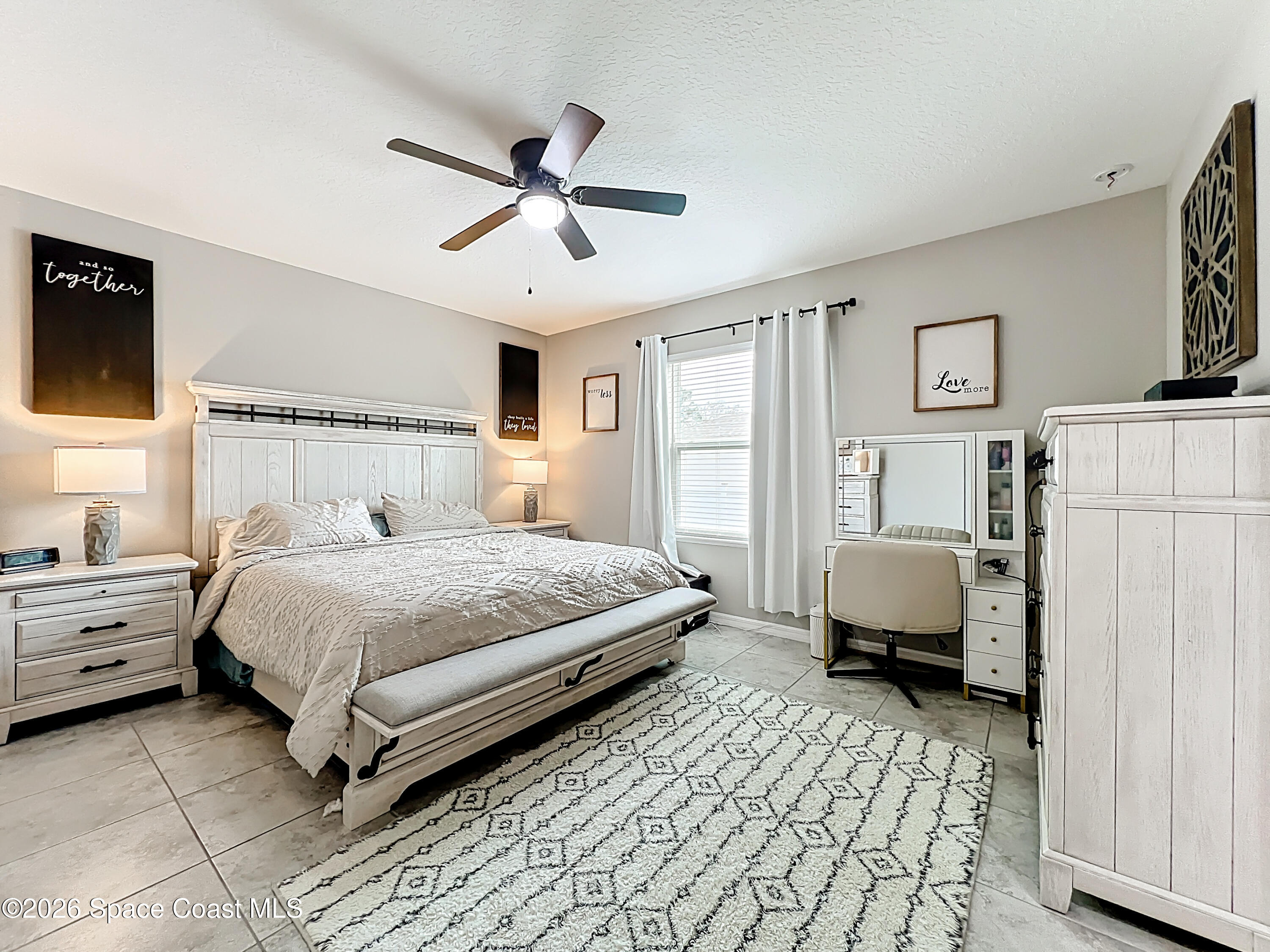 415 Scodella Street Southwest Palm Bay, FL 32908 - Photo 30 of 54 a bedroom with a bed and a chandelier