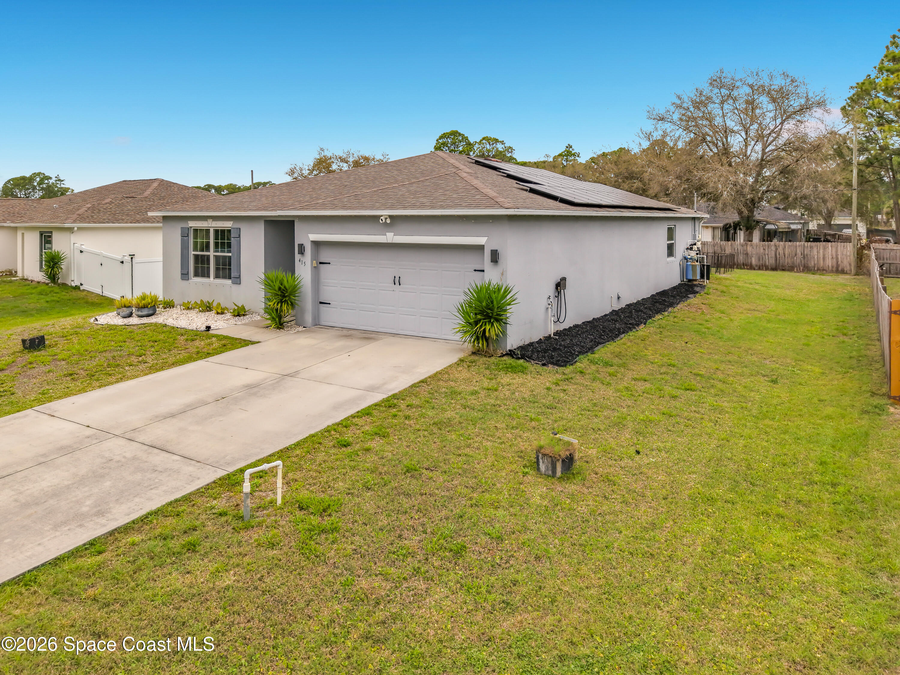 415 Scodella Street Southwest Palm Bay, FL 32908 - Photo 3 of 54 a view of outdoor space yard and front view of a house