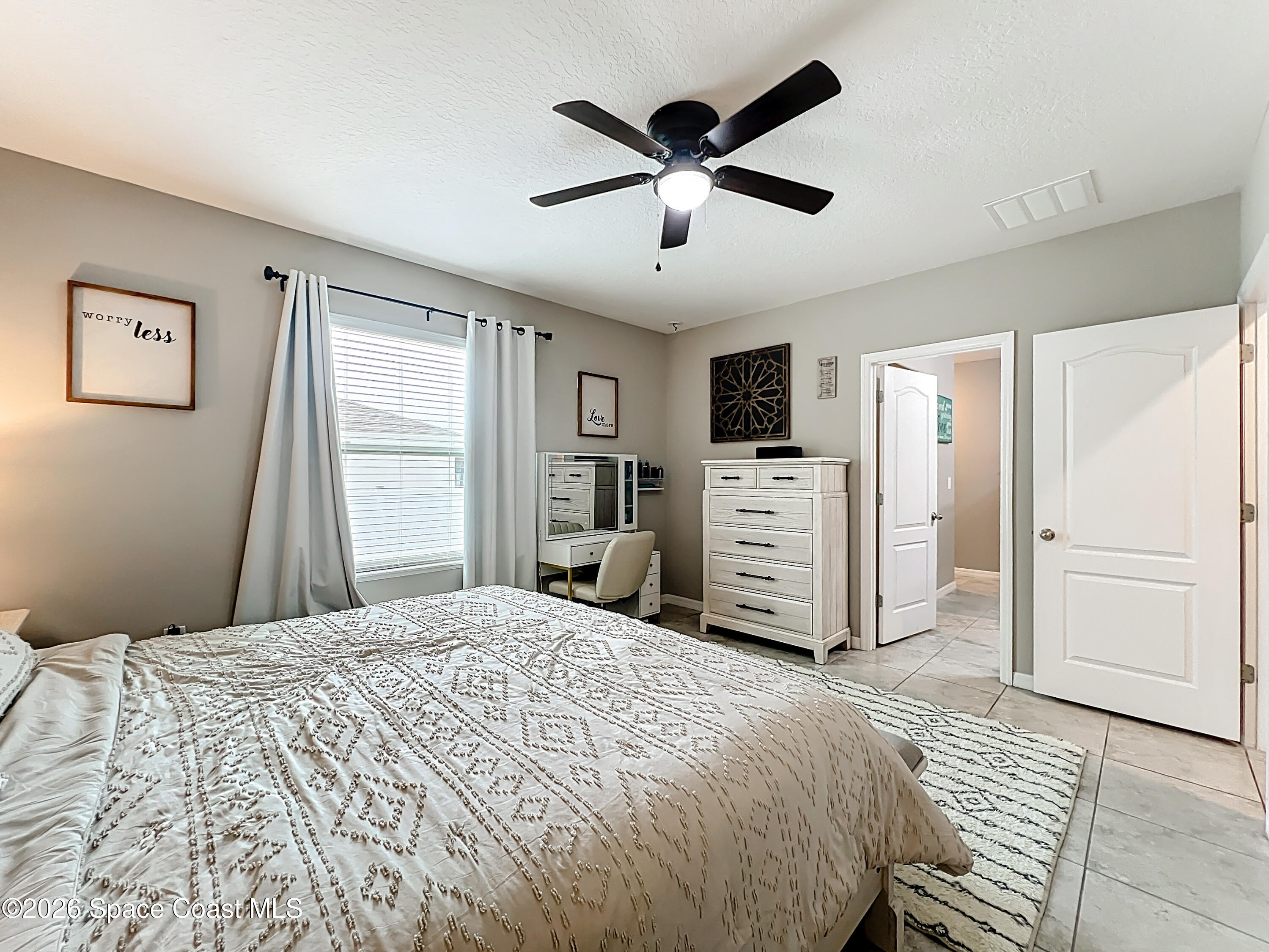 415 Scodella Street Southwest Palm Bay, FL 32908 - Photo 31 of 54 a bedroom with a large bed and a window