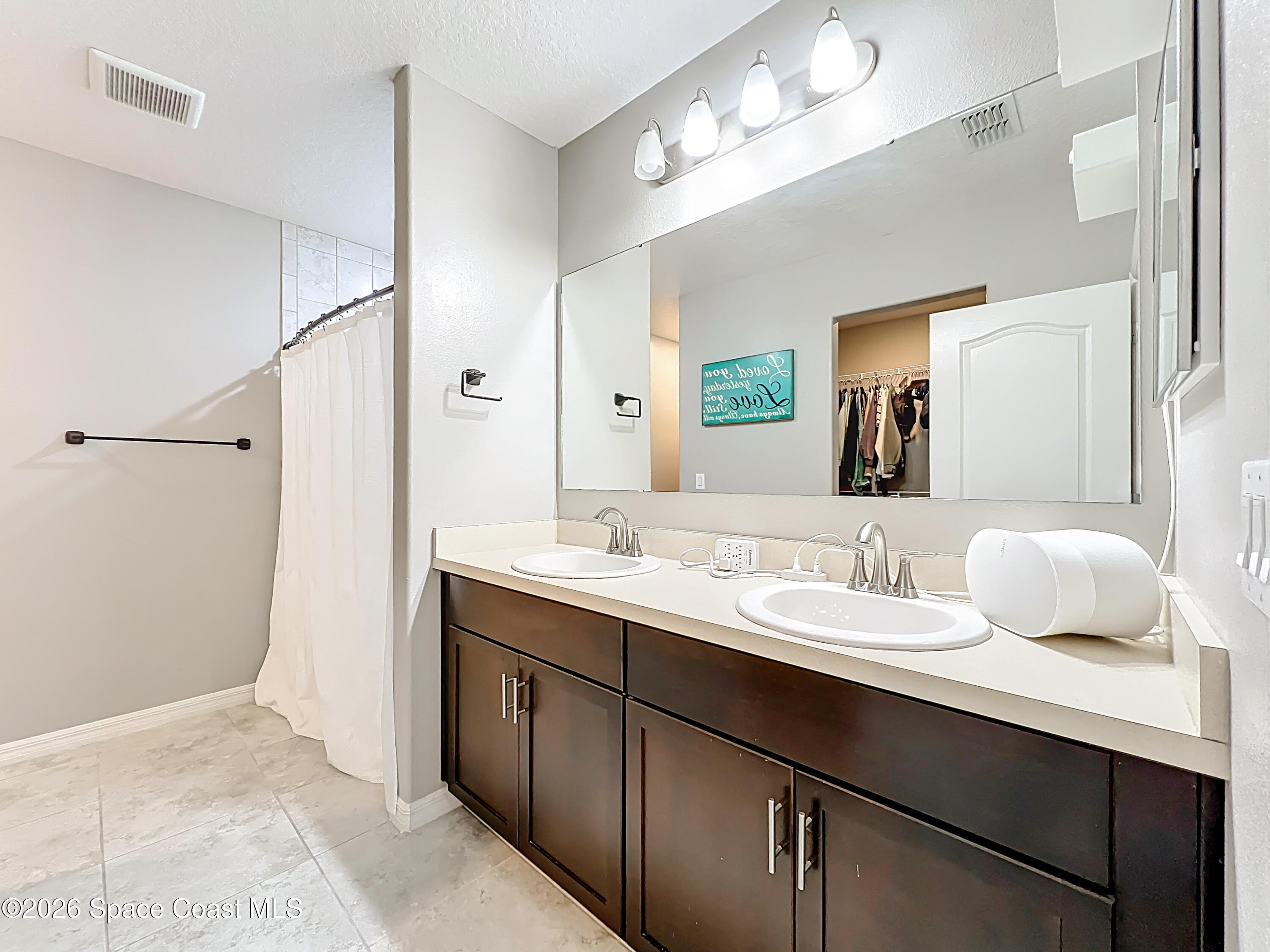 415 Scodella Street Southwest Palm Bay, FL 32908 - Photo 33 of 54 a en suite bathroom with a double vanity sink and a mirror