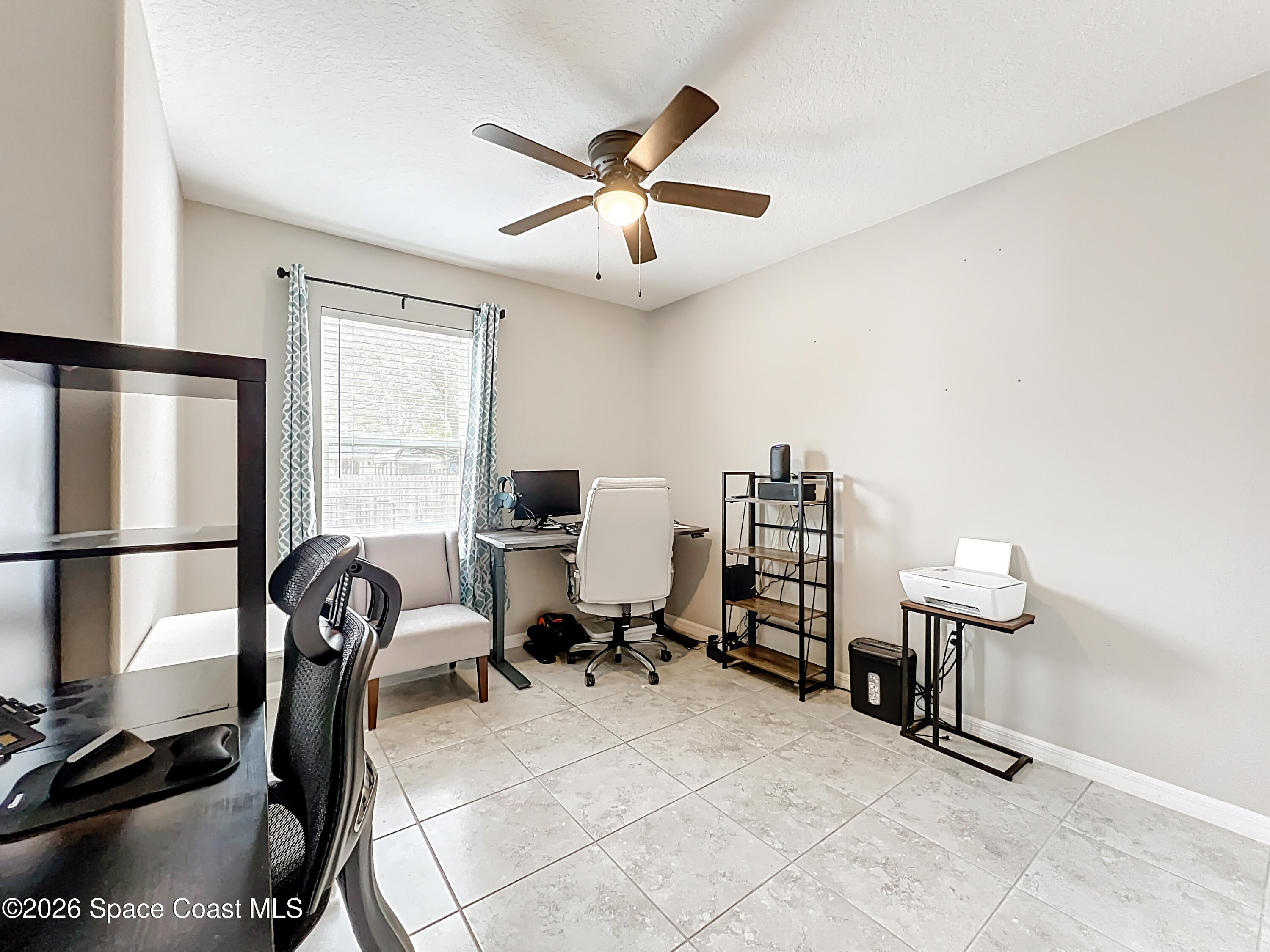 415 Scodella Street Southwest Palm Bay, FL 32908 - Photo 35 of 54 a view of a workspace with furniture and a window