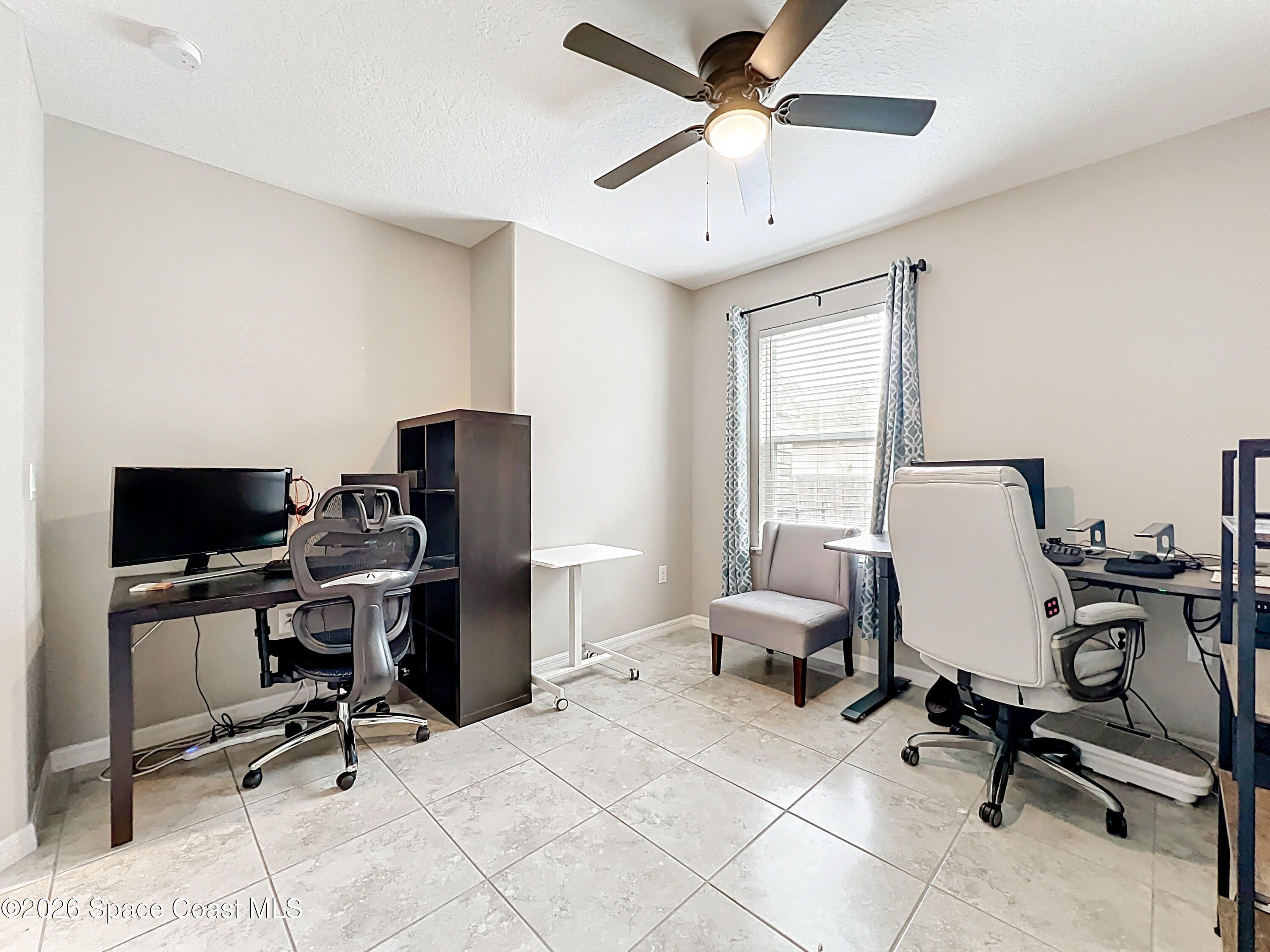 415 Scodella Street Southwest Palm Bay, FL 32908 - Photo 37 of 54 a view of a workspace with furniture and a window
