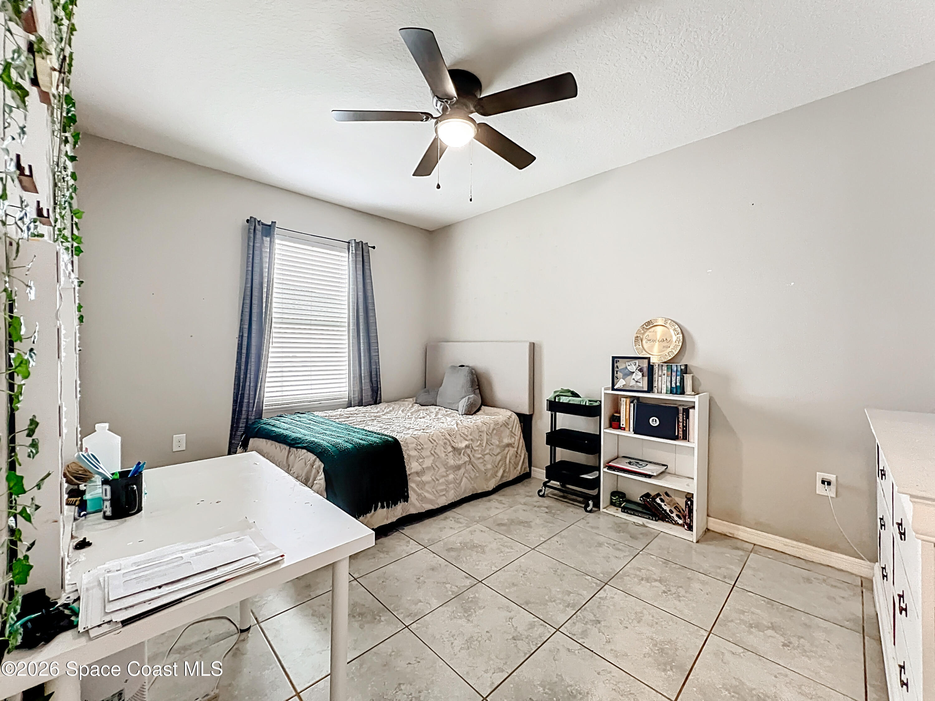 415 Scodella Street Southwest Palm Bay, FL 32908 - Photo 38 of 54 a bedroom with a bed and a table