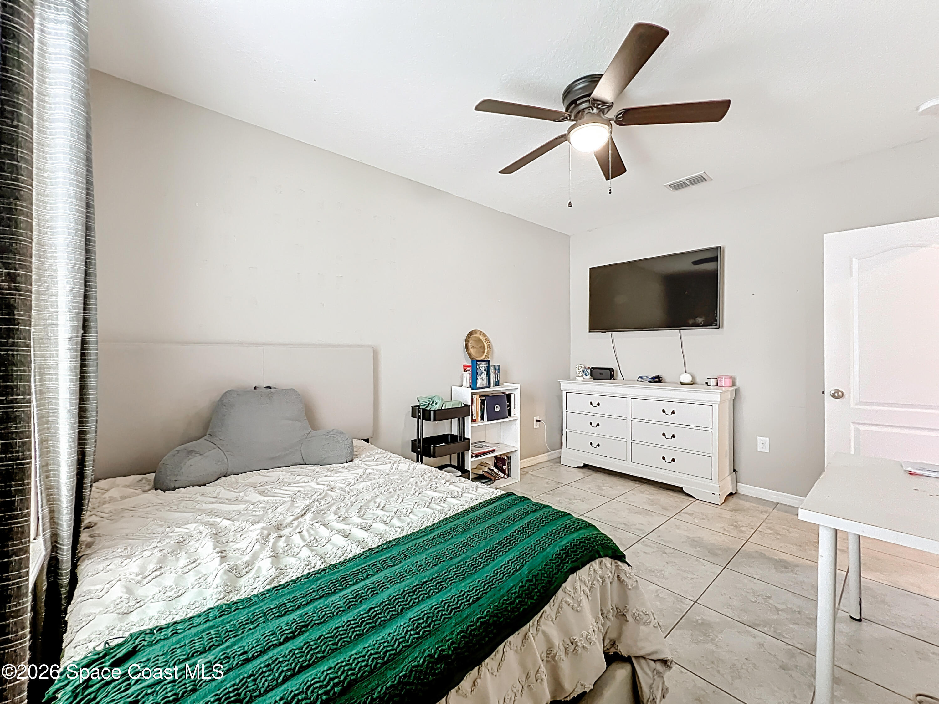 415 Scodella Street Southwest Palm Bay, FL 32908 - Photo 39 of 54 a bedroom with a bed and a flat screen tv