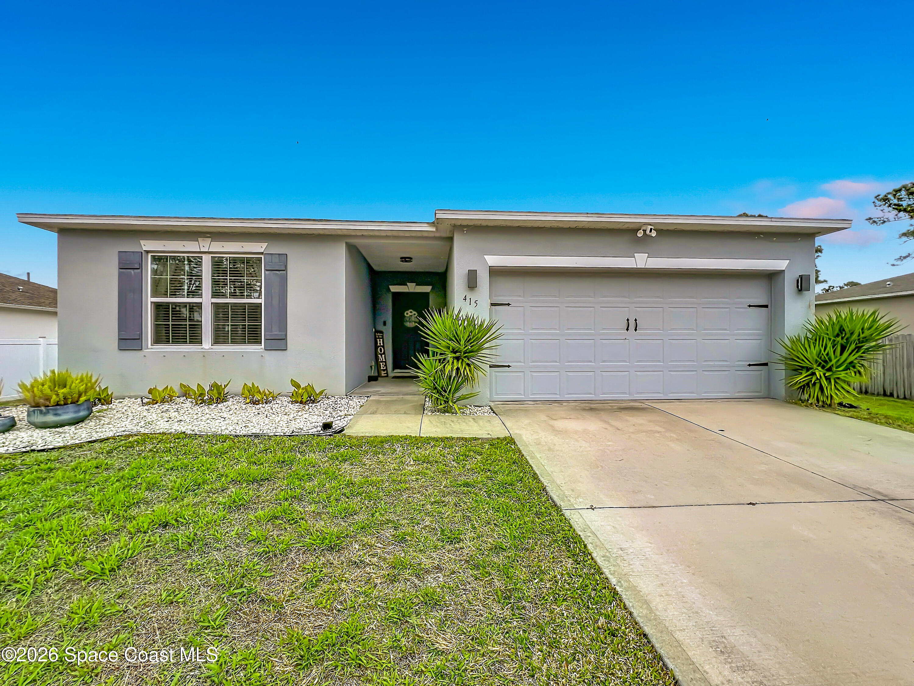 415 Scodella Street Southwest Palm Bay, FL 32908 - Photo 4 of 54 a front view of house with yard