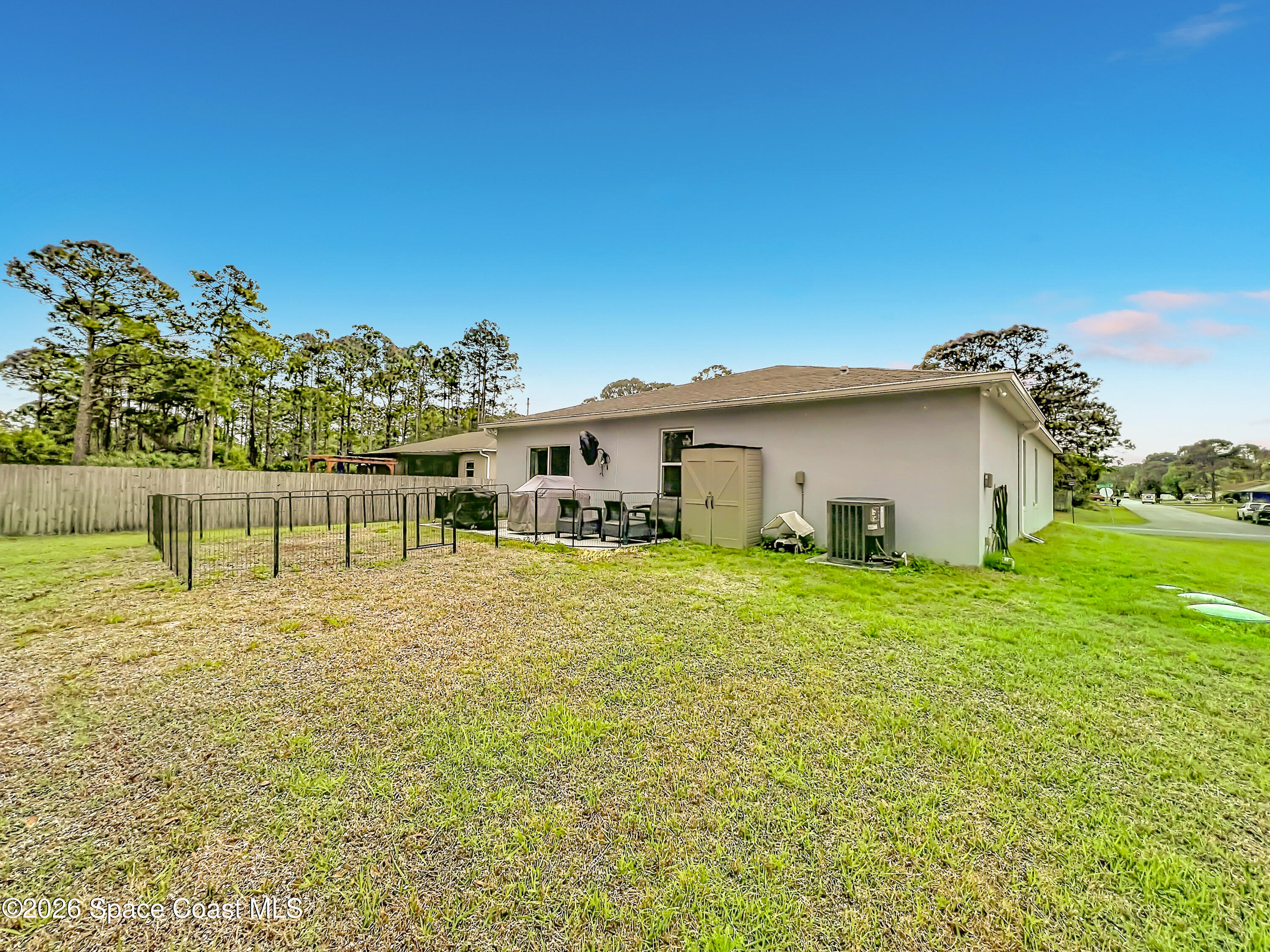 415 Scodella Street Southwest Palm Bay, FL 32908 - Photo 45 of 54 a front view of a house with a garden